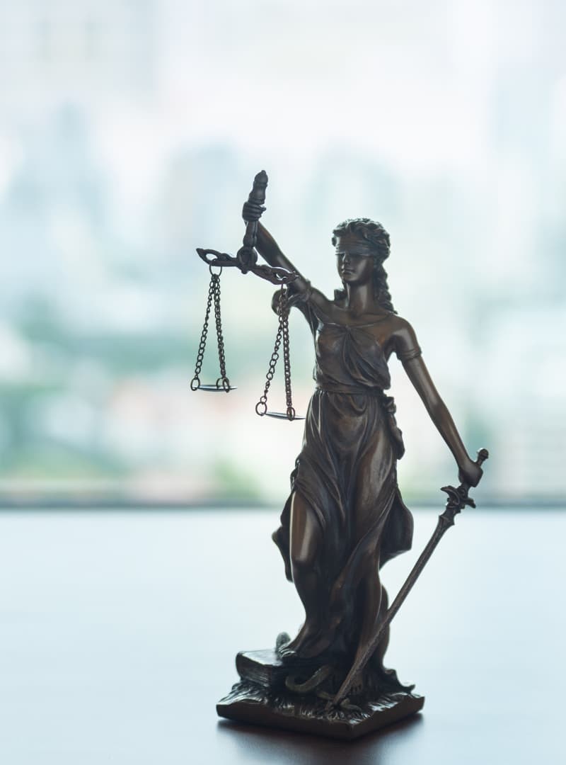 AN image of lady justice on a lawyer's desk. 